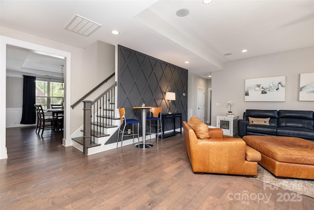 living room featuring wood finished floors, recessed lighting, stairway, and baseboards