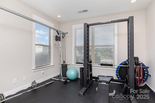 exercise area with baseboards, healthy amount of natural light, and recessed lighting