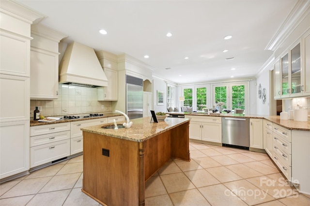 5701 Challisford Ln, Charlotte, NC 28226 - kitchen featuring crown molding, a sink, custom exhaust hood, stainless steel appliances, and light tile patterned flooring