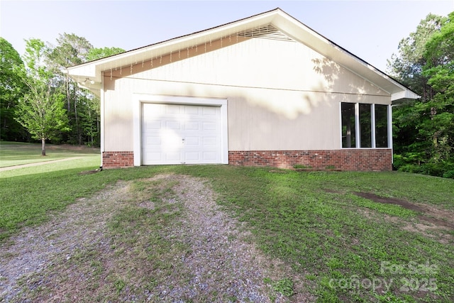 view of home's exterior with a garage, a yard, and driveway