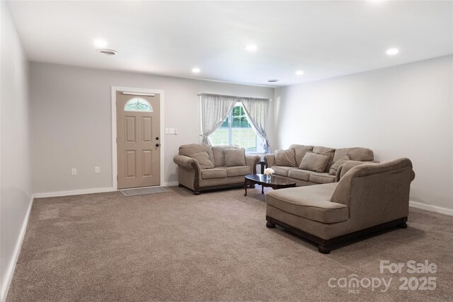 living room with baseboards, recessed lighting, and light carpet