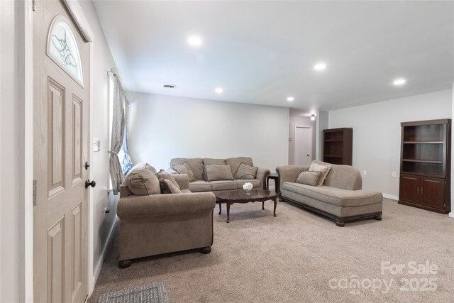 living area with light colored carpet, recessed lighting, and baseboards