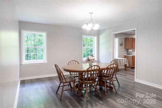 dining area with a healthy amount of sunlight, baseboards, dark wood-style floors, and a chandelier