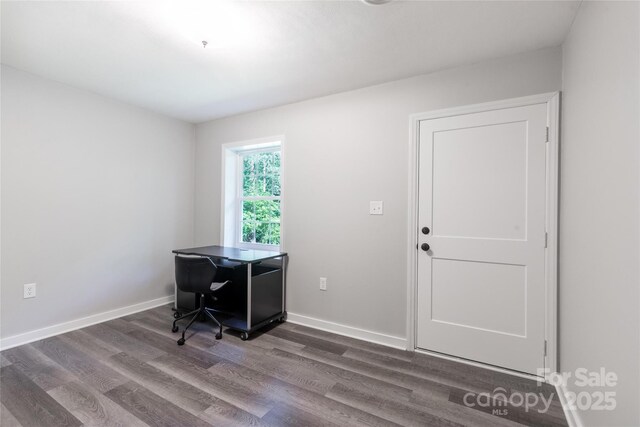 office space with baseboards and dark wood finished floors