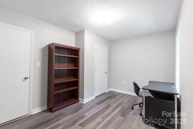 office with baseboards and wood finished floors