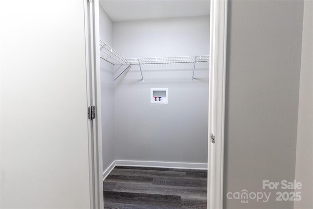 laundry area with baseboards, laundry area, hookup for a washing machine, and wood finished floors