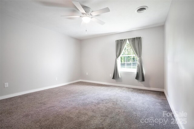 unfurnished room with carpet flooring, a ceiling fan, baseboards, and visible vents