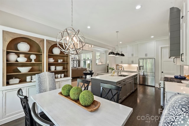 dining area with dark wood-style flooring, a notable chandelier, recessed lighting, and crown molding