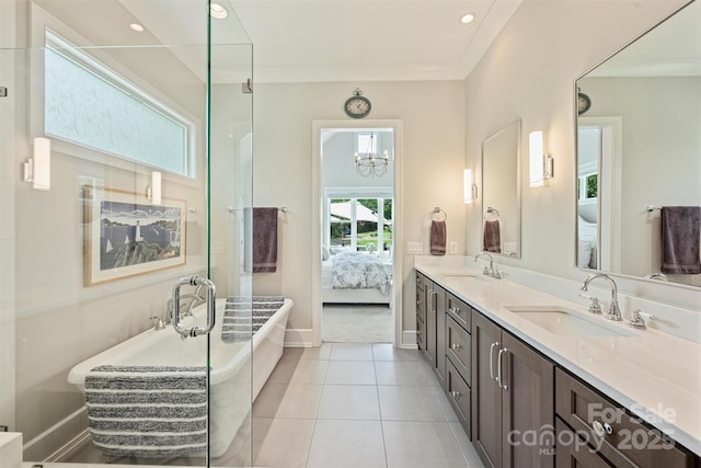 bathroom with baseboards, ensuite bath, double vanity, and a sink