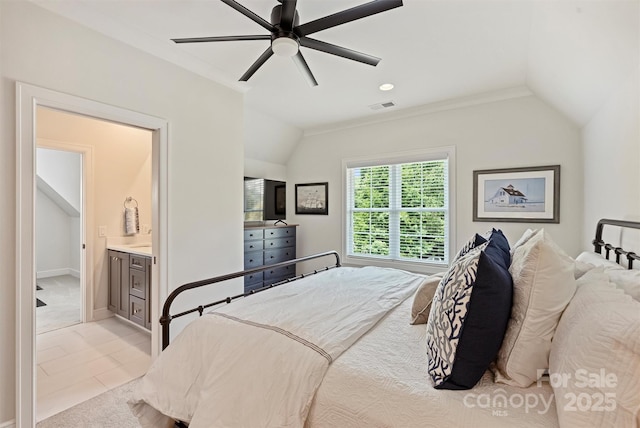 bedroom featuring lofted ceiling, visible vents, light carpet, a ceiling fan, and connected bathroom