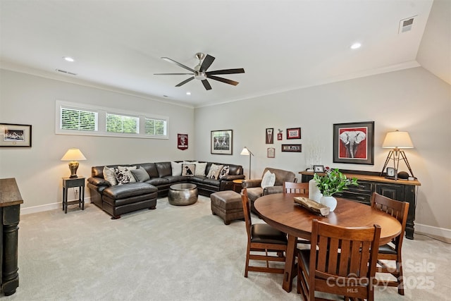 living area featuring baseboards, a ceiling fan, and visible vents