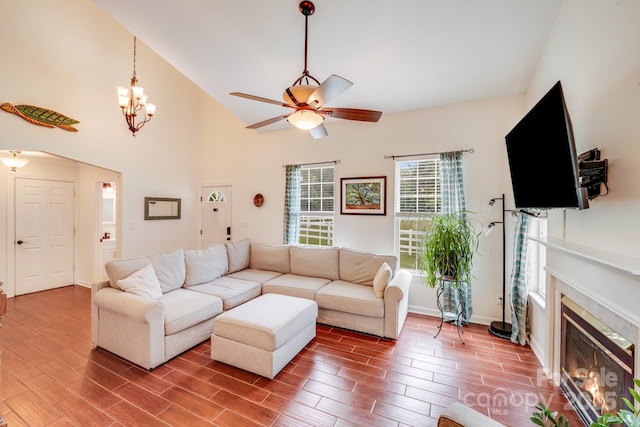 6910 Birdsong Ln, Waxhaw, NC 28173 - living room with a ceiling fan, wood finished floors, a glass covered fireplace, baseboards, and vaulted ceiling