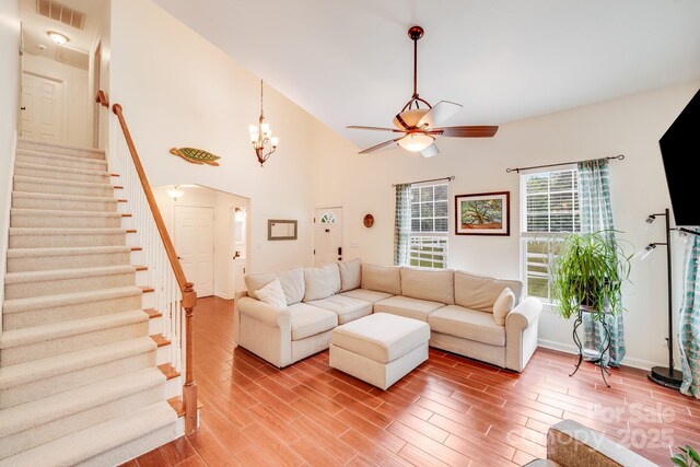 6910 Birdsong Ln, Waxhaw, NC 28173 - living area featuring ceiling fan, stairway, light wood-style floors, and baseboards