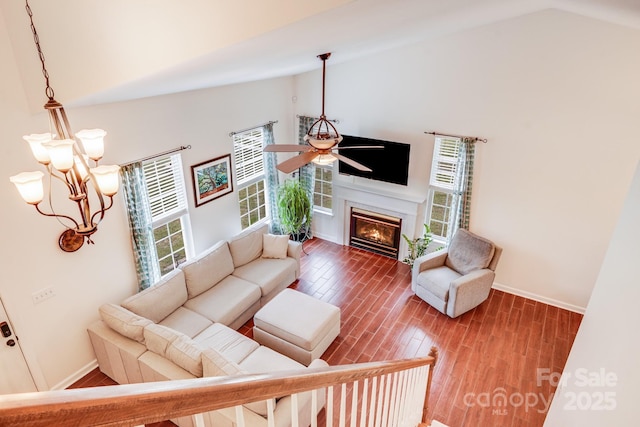 6910 Birdsong Ln, Waxhaw, NC 28173 - living room with a ceiling fan, wood finished floors, high vaulted ceiling, a glass covered fireplace, and baseboards
