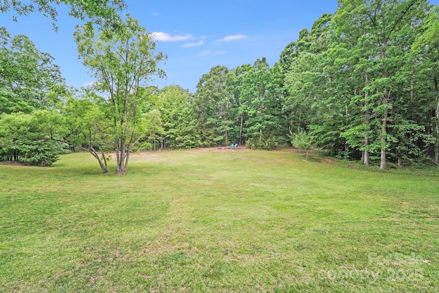 6910 Birdsong Ln, Waxhaw, NC 28173 - view of green lawn featuring a wooded view
