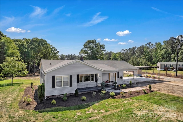 159 Old Home Pl, China Grove, NC 28023 - view of front of house featuring dirt driveway, a front lawn, covered porch, and a carport