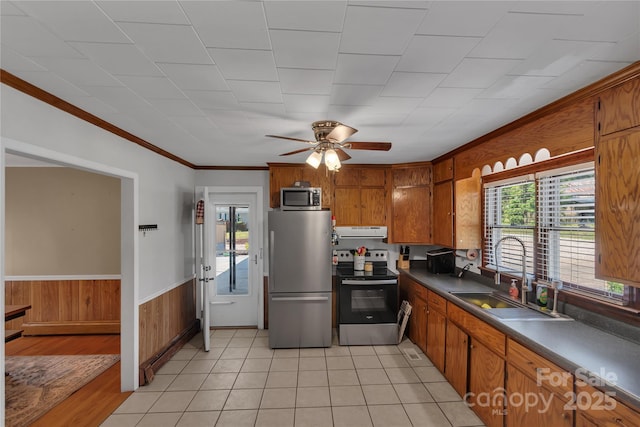 159 Old Home Pl, China Grove, NC 28023 - kitchen with brown cabinetry, range hood, plenty of natural light, a sink, and appliances with stainless steel finishes