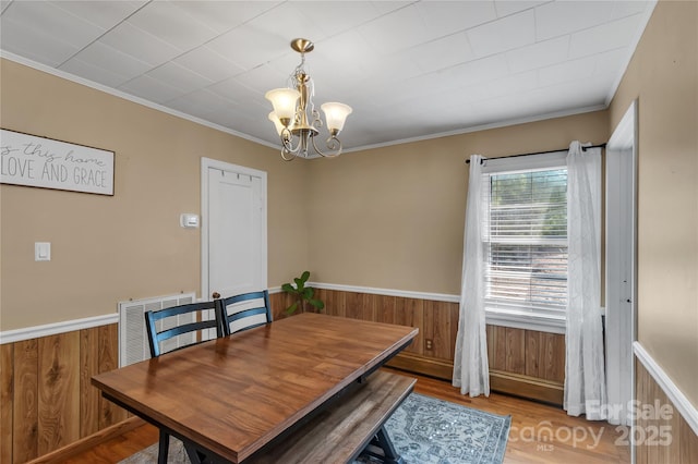159 Old Home Pl, China Grove, NC 28023 - dining area featuring an inviting chandelier, wooden walls, crown molding, and visible vents