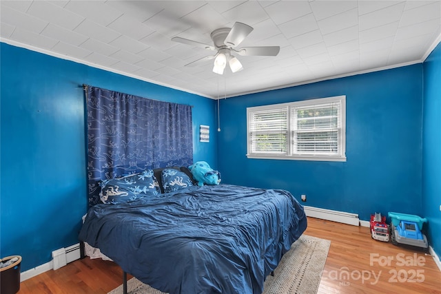 159 Old Home Pl, China Grove, NC 28023 - bedroom with ornamental molding, a ceiling fan, wood finished floors, and baseboard heating