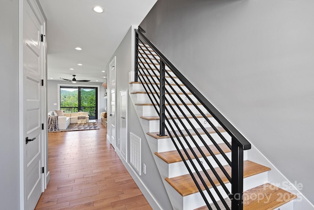 stairway featuring visible vents, wood finished floors, baseboards, recessed lighting, and a ceiling fan