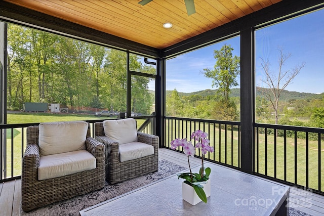 sunroom / solarium with a ceiling fan and a healthy amount of sunlight