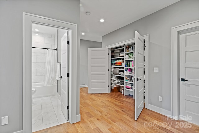 interior space with baseboards and recessed lighting