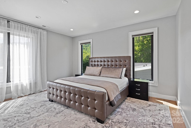 bedroom featuring recessed lighting, baseboards, wood finished floors, and visible vents