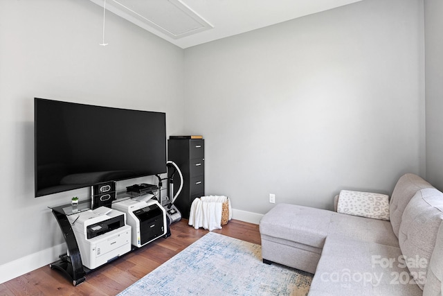 interior space with baseboards, attic access, and dark wood-style floors