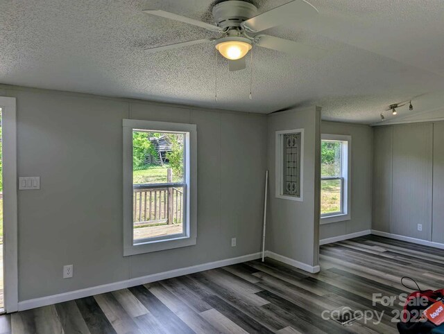 unfurnished room with baseboards, a textured ceiling, ceiling fan, and wood finished floors