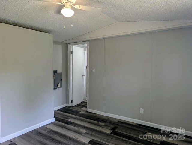 unfurnished room with a ceiling fan, dark wood-style floors, a textured ceiling, and lofted ceiling