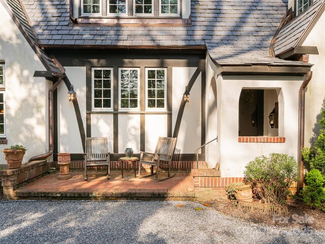 341 Vanderbilt Rd, Asheville, NC 28803 - doorway to property featuring a high end roof and stucco siding