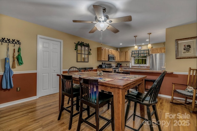 385 N Fork Rd, Black Mountain, NC 28711 - dining room with light wood-style floors, baseboards, and a ceiling fan