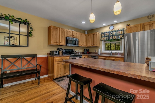 385 N Fork Rd, Black Mountain, NC 28711 - kitchen featuring a kitchen breakfast bar, appliances with stainless steel finishes, light wood-type flooring, a sink, and recessed lighting