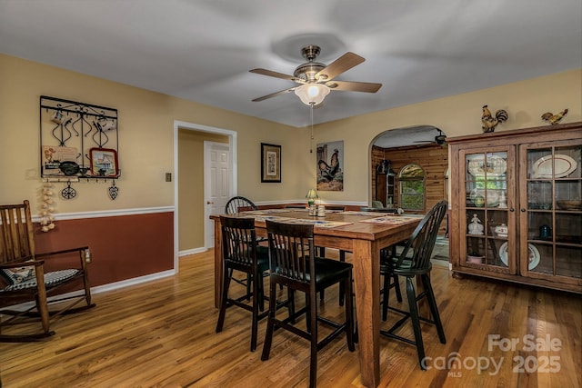 385 N Fork Rd, Black Mountain, NC 28711 - dining area featuring arched walkways, baseboards, a ceiling fan, and wood finished floors