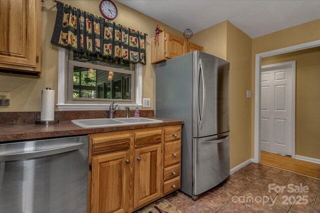 385 N Fork Rd, Black Mountain, NC 28711 - kitchen featuring baseboards, a sink, dark countertops, and stainless steel appliances