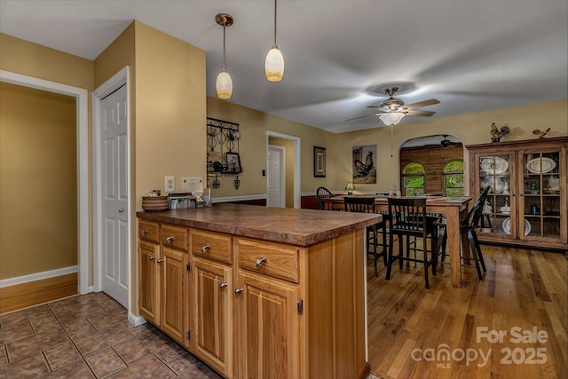 385 N Fork Rd, Black Mountain, NC 28711 - kitchen featuring pendant lighting, dark wood-style flooring, a peninsula, dark countertops, and a ceiling fan