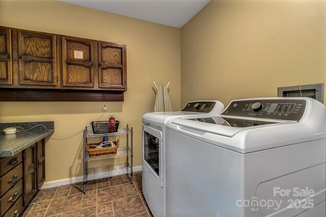 385 N Fork Rd, Black Mountain, NC 28711 - laundry room with baseboards, cabinet space, independent washer and dryer, and stone finish floor