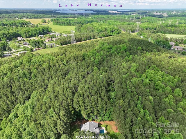 aerial view of property's location featuring a forest
