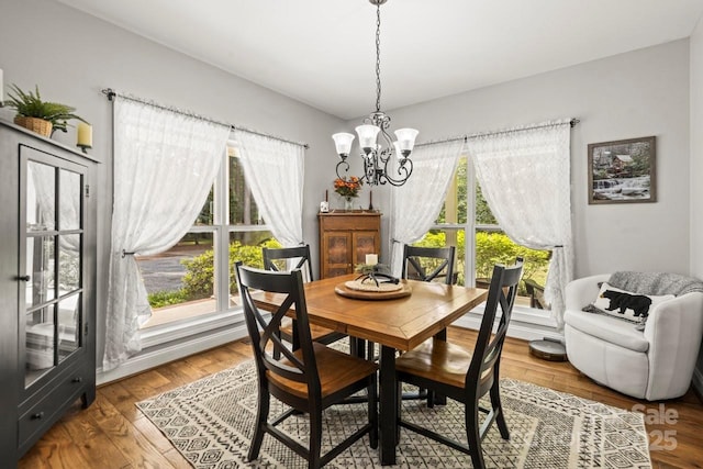 dining room featuring plenty of natural light, a chandelier, and wood finished floors