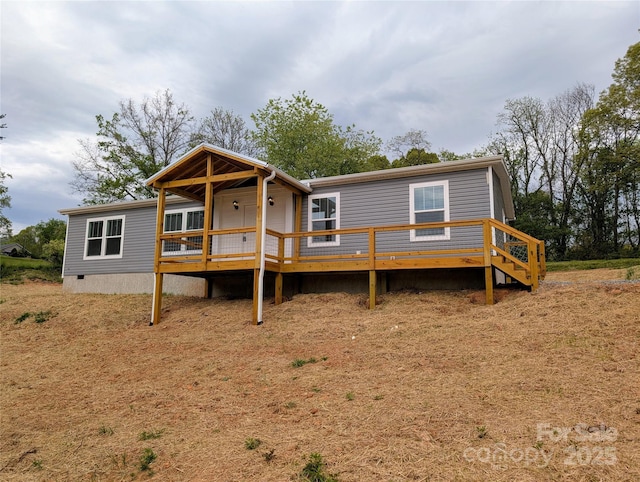 back of house with a wooden deck and crawl space