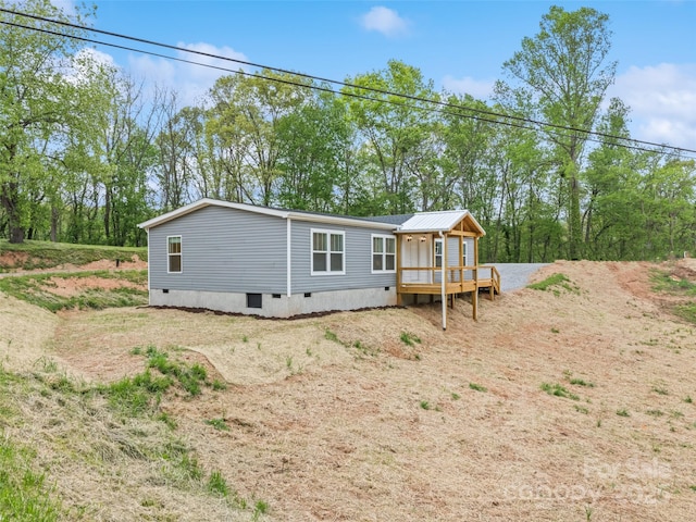 exterior space featuring a wooden deck and crawl space