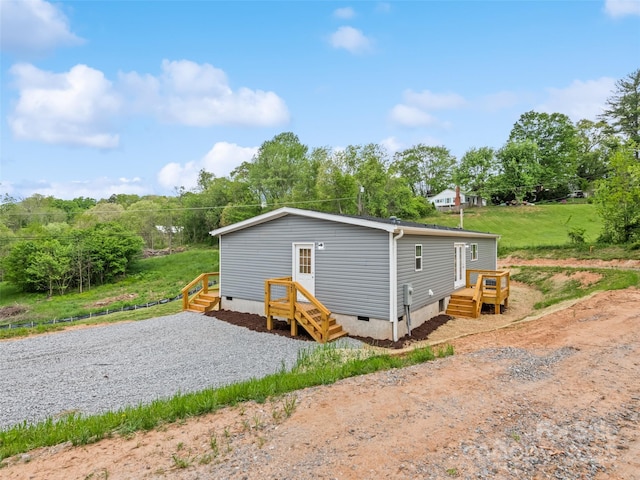rear view of property featuring crawl space
