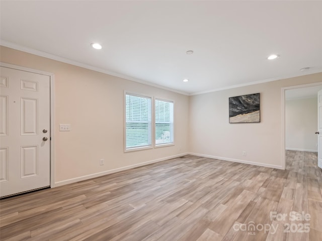 unfurnished living room with crown molding, recessed lighting, light wood-style floors, and baseboards