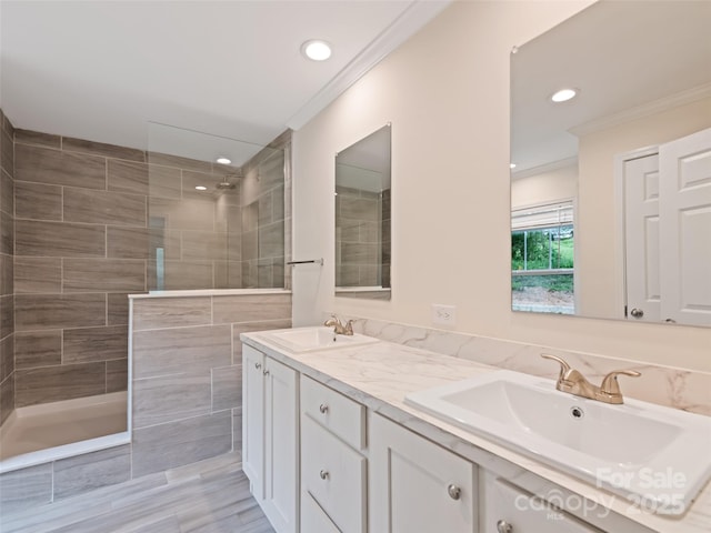 full bath with crown molding, recessed lighting, walk in shower, and a sink