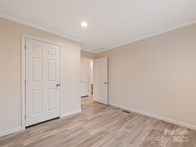unfurnished bedroom with recessed lighting, light wood finished floors, crown molding, and baseboards