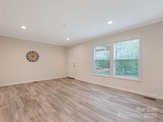 unfurnished room with crown molding, recessed lighting, baseboards, and visible vents