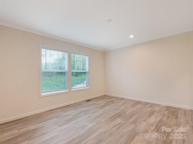 empty room with visible vents, crown molding, baseboards, light wood-style floors, and recessed lighting