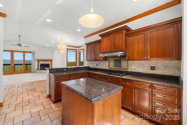 117 Distant View Dr, Asheville, NC 28803 - kitchen with under cabinet range hood, a peninsula, black gas cooktop, decorative backsplash, and recessed lighting