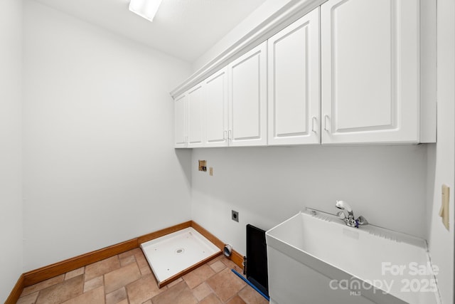 117 Distant View Dr, Asheville, NC 28803 - clothes washing area featuring baseboards, cabinet space, light stone finish flooring, and hookup for an electric dryer