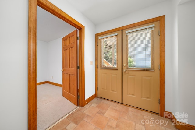 117 Distant View Dr, Asheville, NC 28803 - foyer with baseboards, light stone finish flooring, light carpet, and french doors